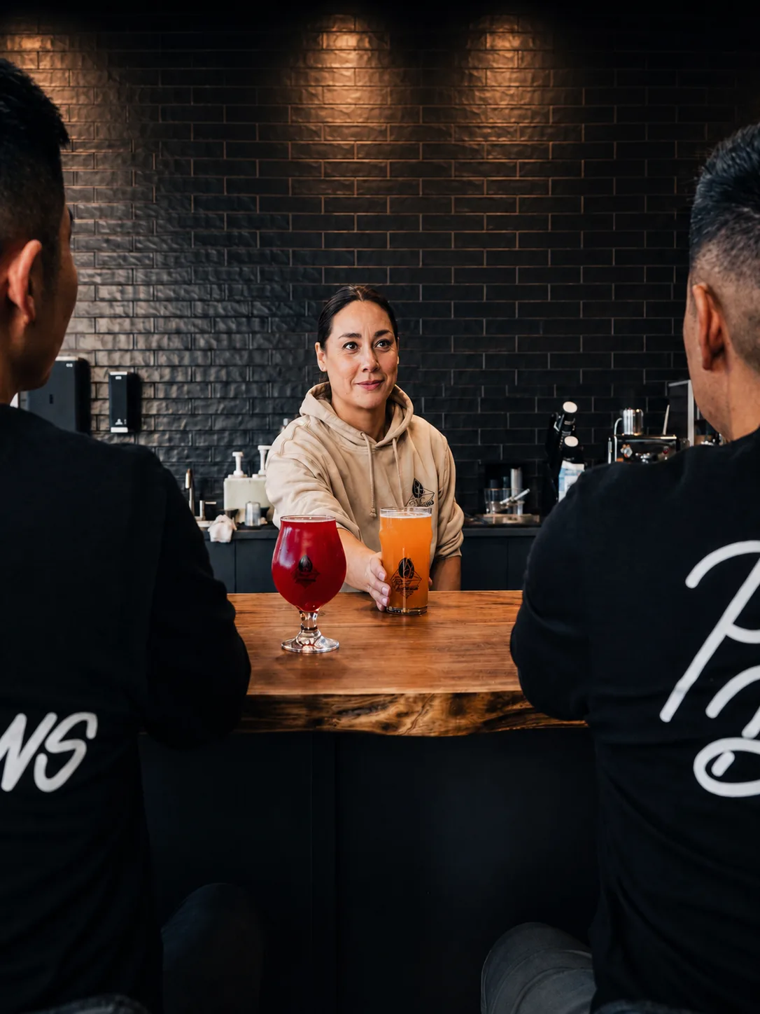 A Pour Decisions Craft barista serving craft drinks to guests at the bar