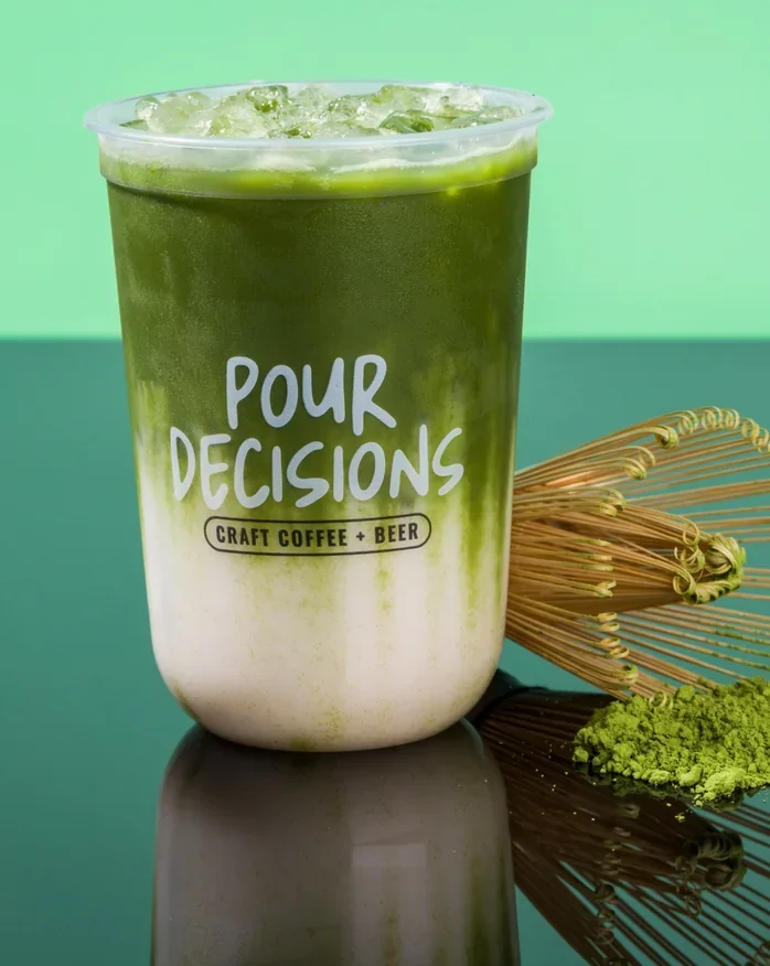 Iced ceremonial matcha with a bamboo whisk